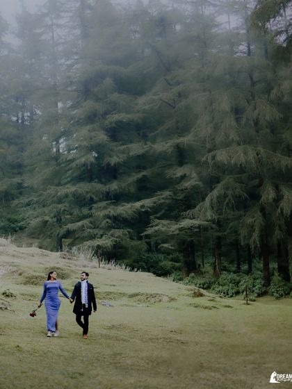 A romantic walk through a lush, green meadow in the mountains. This shot captures the feeling of being lost in nature and in love.