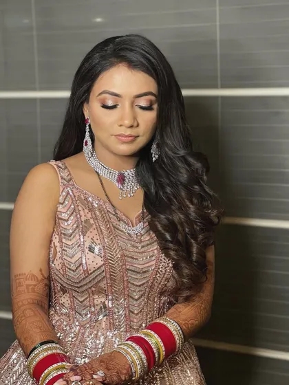 A close up of the bride's reception look. The soft waves are elegant and timeless, perfectly complementing her diamond jewelry.