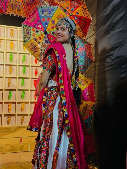 Posing with a colorful embroidered umbrella, which you can also rent from me! This traditional white and red chaniya choli is perfect for creating those picture-perfect moments.