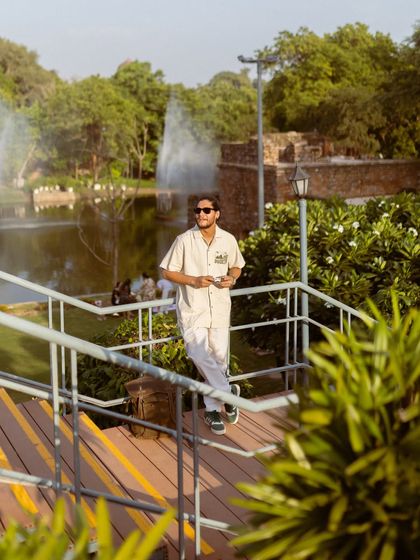 Another look from the Royal Enfield apparel shoot, this time on a wooden walkway by a lake. The scenic background adds a sense of calm and exploration to the brand's image.