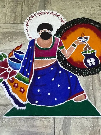 A figurative rangoli showing a woman in a traditional saree holding a diya. This type of artistic floor decor is perfect for adding a touch of grace and custom artistry to a festive event at home or a venue.