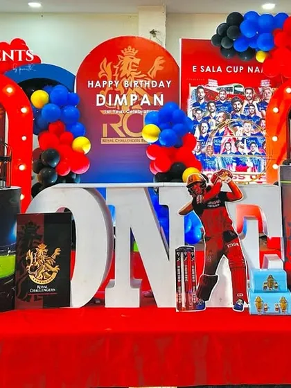 For the little cricket fan, I designed this high-energy RCB themed party. It features the team's iconic red, blue, and gold colors, player cutouts, and custom marquee numbers, making it a sure hit for any supporter.