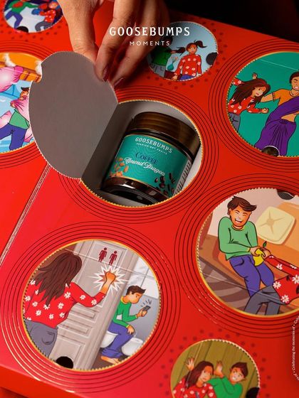 The interactive design of my Rakhi gift box continues. This image shows another window being opened to find a jar of Coffee Almond Dragees, making the unboxing as exciting as the treats inside.