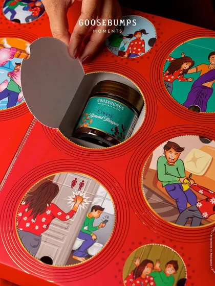 The interactive design of my Rakhi gift box continues. This image shows another window being opened to find a jar of Coffee Almond Dragees, making the unboxing as exciting as the treats inside.