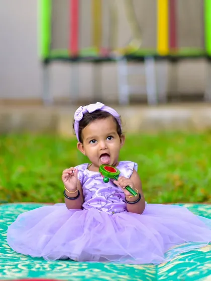 It's the unplanned, in-between moments that are often the most precious. Here, she's completely absorbed with her toy, giving us a genuine, candid shot that tells a little story of her playful nature.