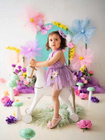 Posing like a pro on her white rocking horse. This toddler photoshoot was full of fun and personality.
