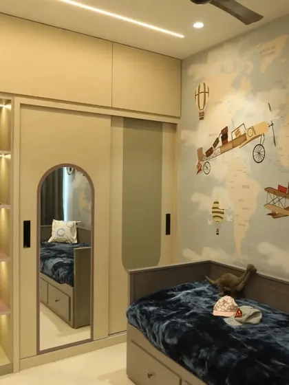 This view of the travel-themed room shows the sliding wardrobe with an arched mirror and a built-in, illuminated display shelf for showcasing trophies, collectibles, or favorite toys.