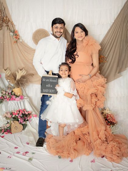 The whole family is excited to welcome a baby boy. This portrait in our boho-chic setup with a beautiful peach gown shows how we include older siblings in the celebration.