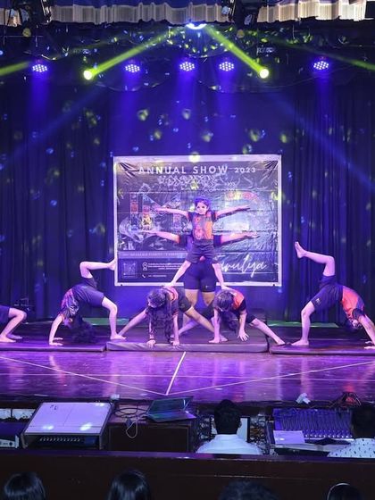 A wide shot capturing the scale of our stage performances. With professional lighting and a large stage, our students get the full experience of performing for a live audience.