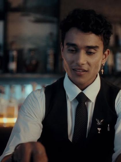 A sharp, professional look for the bartender character in the Dezerv ad, complete with a vest, tie, and custom pin.