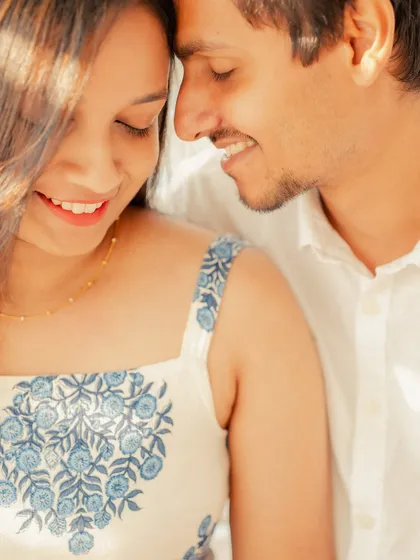 Another close-up from their modern pre-wedding shoot, focusing on their smiles and easy connection. The blue floral pattern on her dress adds a lovely pop of color.