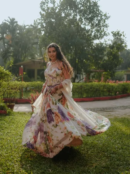 A beautiful shot of the bride twirling in her floral gown. The motion captures the flow of her dress and her joyful spirit.