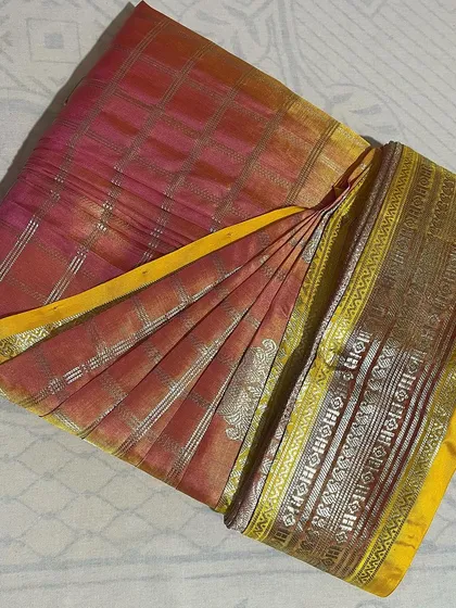 A beautiful checked silk saree with a yellow border, showcasing the sharp pleats from my folding service.