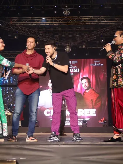 Interacting with the Meet Bros on stage, showing my versatility in hosting for various Bollywood artists.