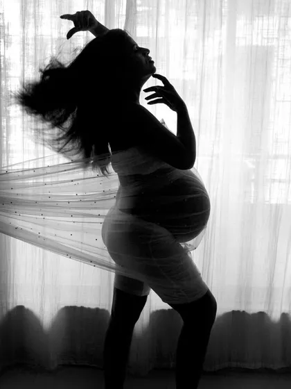 A full-frame version of the artistic silhouette. The motion in the hair and fabric adds a dynamic and expressive quality to this black and white shot.