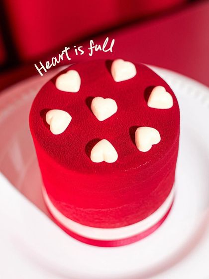 Our Valentine's special, the Red Hot Velvet Cake, with its striking red velvet finish and white chocolate hearts.