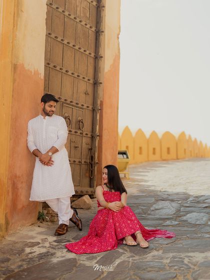 A classic pre-wedding pose against a grand wooden door, the contrast between the couple and the architecture creating a stunning visual.