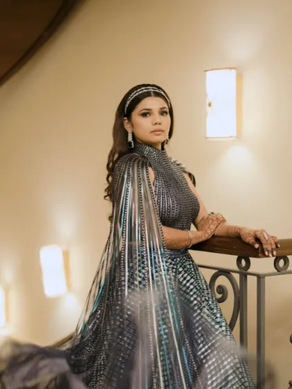 A glamorous Sangeet look with soft waves and a statement headband, creating a chic and modern bridal style.