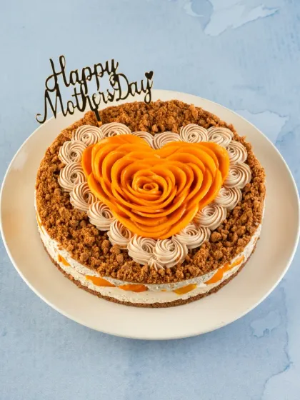 For the Mom's Mango Biscoff Cheesecake, I combine creamy mango cheesecake with a crunchy Biscoff crust and top it with a heart-shaped mango rose.