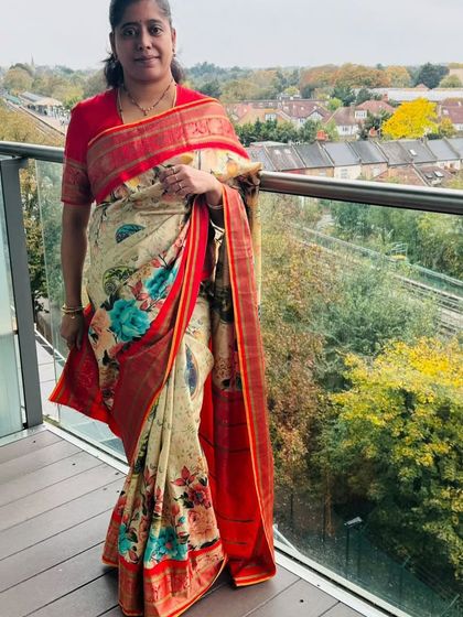 Our client Spurthi wears tradition with confidence in our floral print silk saree with a rich red border.