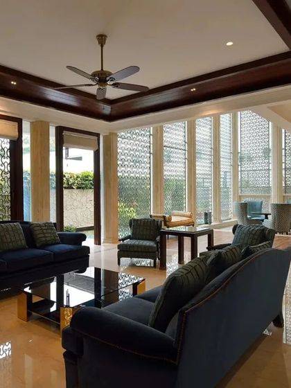 Another view of the classic living room, showing the full effect of the floor-to-ceiling windows and decorative screens that filter light beautifully. The layout is designed to be both grand and comfortable.