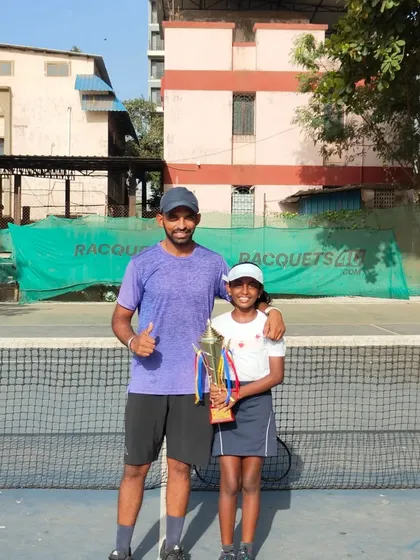 A proud coach with Trisha after her milestone first U-10 victory.