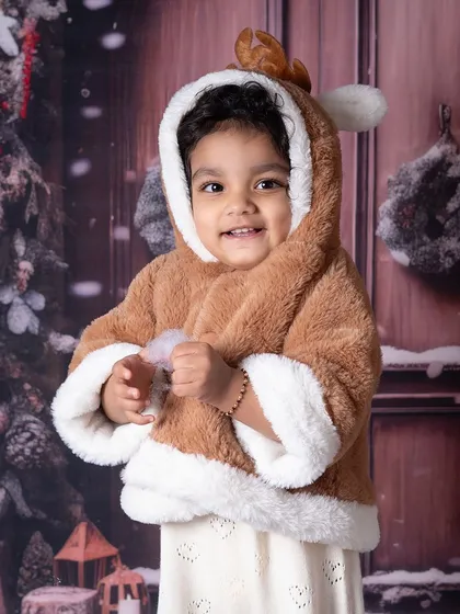 This little one dressed as a reindeer is the definition of cute. The cozy, furry outfit is perfect for a winter-themed shoot.