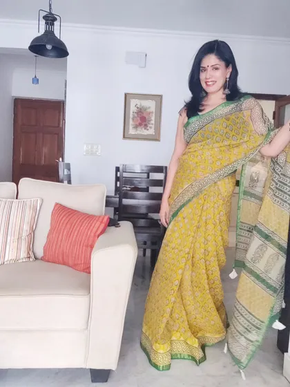 A full-length view of the yellow Kota Doriya saree, showing its lovely drape and summery feel.