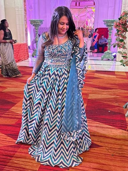 For those who love bold patterns, this chevron-print lehenga in shades of blue is a fantastic choice. The modern print combined with an embellished blouse creates a striking Indo-Western look.