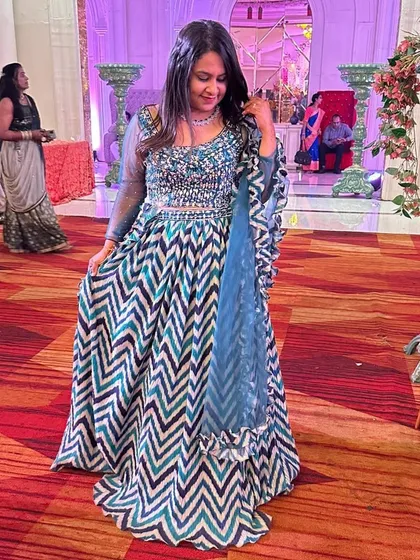 For those who love bold patterns, this chevron-print lehenga in shades of blue is a fantastic choice. The modern print combined with an embellished blouse creates a striking Indo-Western look.