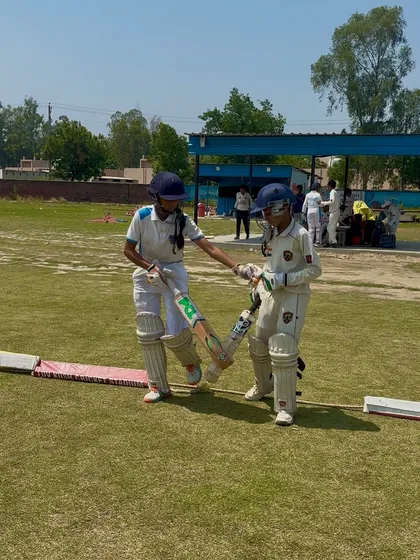 The opening partners share a word before starting the innings.