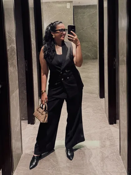 A chic and modern formal look with a black waistcoat and wide-leg pants. This outfit is ideal for hosting a stylish corporate party or an art gallery opening.