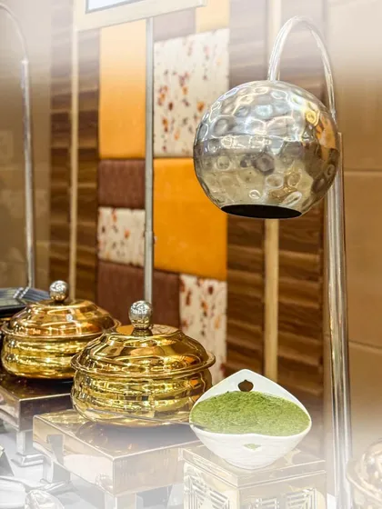 An elegant display of condiments and accompaniments for our starters. The hammered metal bowls and modern lamps add a touch of luxury to the buffet setup.