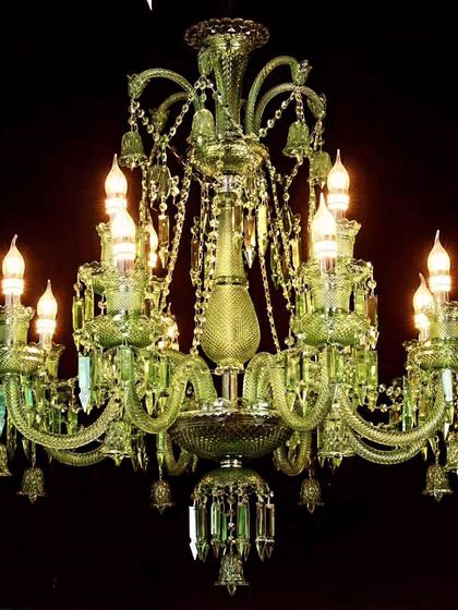 This green Italian crystal chandelier is a statement of bold luxury. The candle-style LED lights and vibrant color make it a perfect centerpiece for a living room that embraces classic design with a twist.