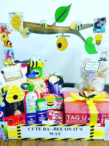 Another take on my popular 'Cute Ba-bee on it's way' theme. This one is packed with chocolates and snacks, and decorated with photos of the couple, making it a very personal gift.