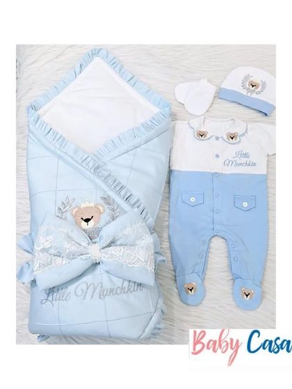 Another view of the "Little Munchkin" set, showing the wrap and romper side by side. The quilted wrap with a large bow perfectly complements the adorable teddy bear romper.