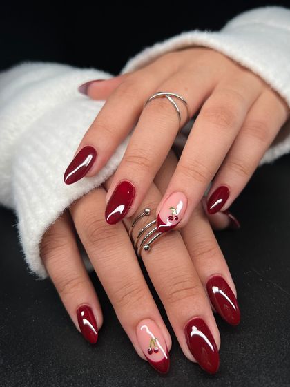 The full view of the red and cherry accent nail set. It's a perfect example of how a small, hand-painted detail can elevate a classic look.