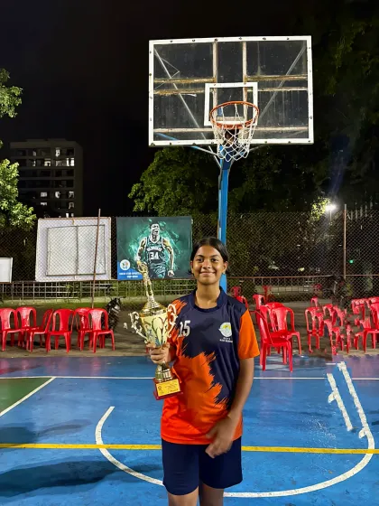 Saisha, one of our promising young athletes, posing with her trophy after a successful tournament. Her hard work and dedication are an inspiration.