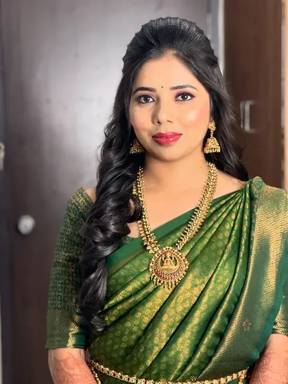 A portrait of the bride, showing her half-up hairstyle with loose curls.
