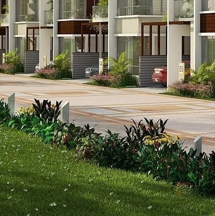 The street view of the Hennur row house community, showing the landscaped common areas and organized driveways for each unit.