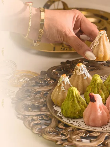 A close-up of my colourful modaks, each one handcrafted with love. Here, I'm arranging a platter with silver varq for that extra touch of festive luxury.