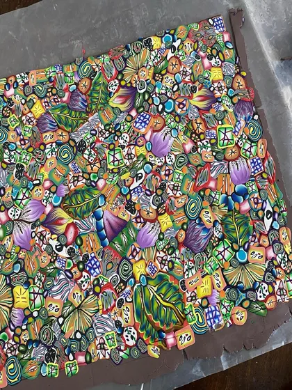A close-up of a polymer clay slab before it becomes a trinket dish. I make these intricate patterns, called clay canes, from scratch. The whole process takes days, but seeing the vibrant, psychedelic design come together is so rewarding.