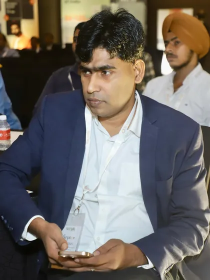 A team member listening intently during a session at the conference. Continuous learning is key to staying ahead in this industry.