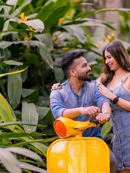 A casual and fun photo with a yellow scooter prop, surrounded by the lush greenery of our garden.