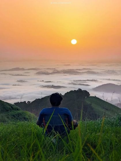 Watching the sunrise above the clouds from a peak in Wayanad. It's a truly heavenly experience.