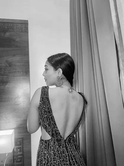 A black and white shot that highlights the beautiful back of the gown and my sun tattoo.