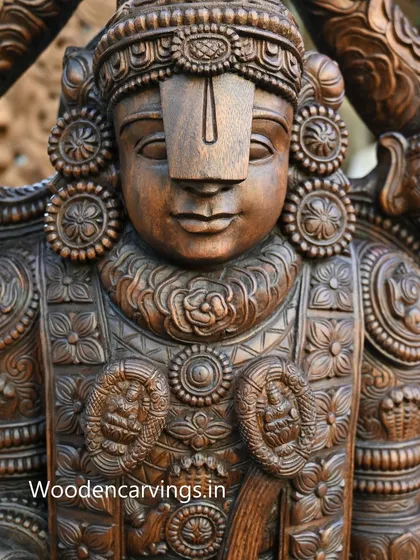 A detailed close-up of the face of the Lord Venkatajalapathy sculpture. The calm, meditative expression is a result of our master carvers' skill in bringing a sense of divine presence to the wood.