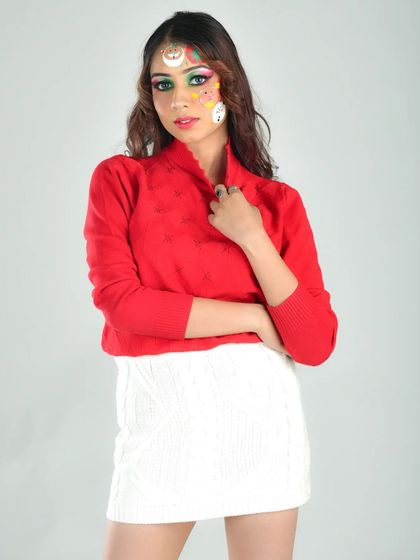 A studio portrait showcasing the complete Christmas look. The bright, festive makeup stands out against the simple background, making it the hero of the image.