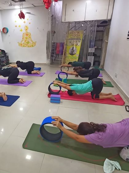 In this class, students are using yoga wheels to open their upper backs in Anahatasana, or Melting Heart Pose. This supported stretch is excellent for releasing tension in the shoulders and thoracic spine.