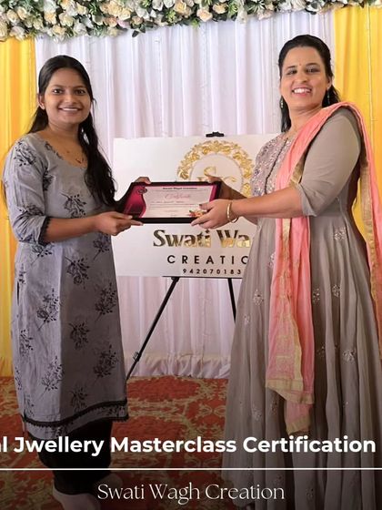 Celebrating the successful completion of the workshop. Each student, like this one, leaves with new skills and the confidence to create their own floral jewelry designs.